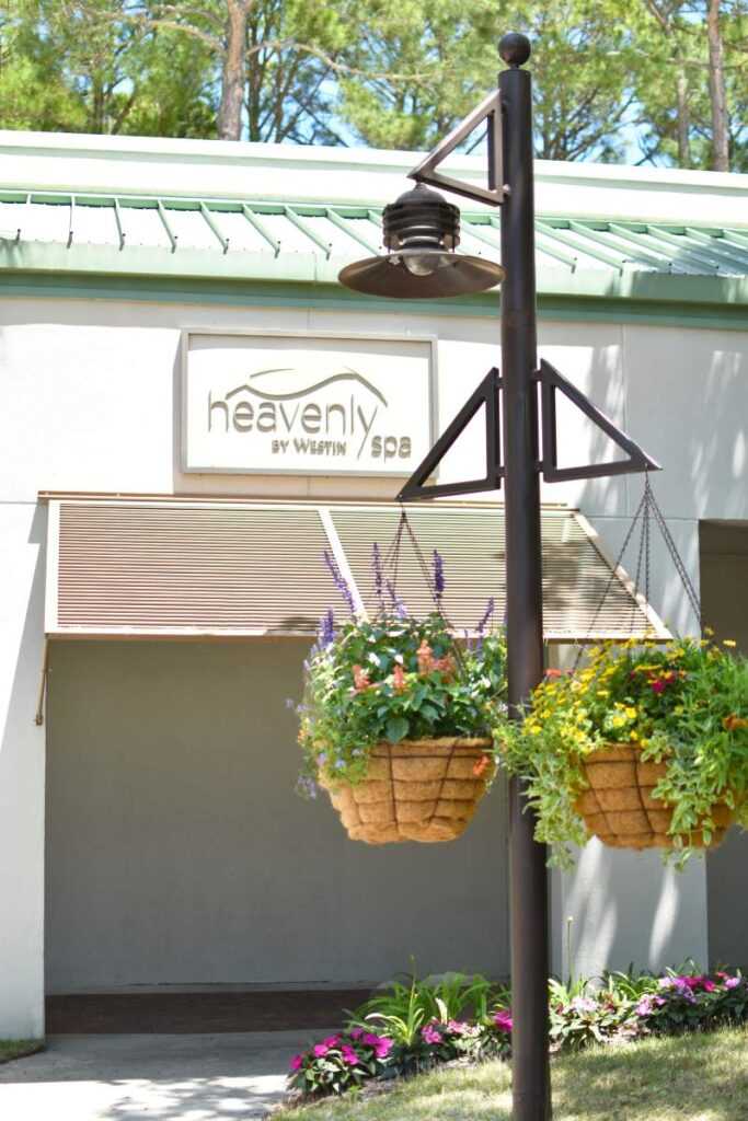 a couple of hanging baskets filled with flowers in front of a building